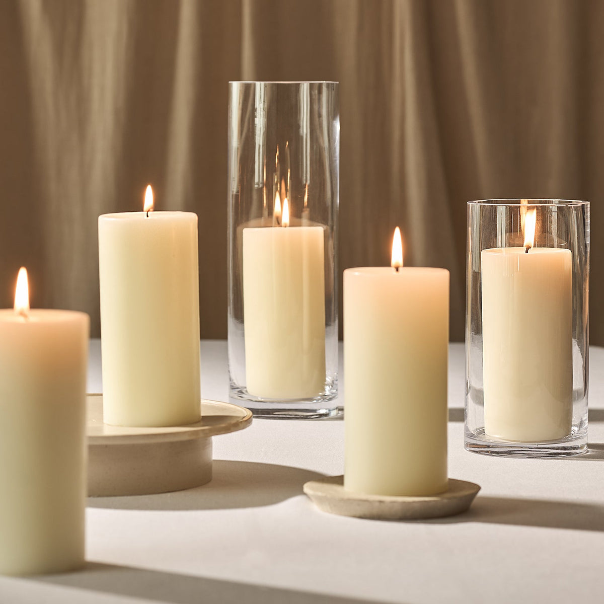 A collection of lit scented pillar candles